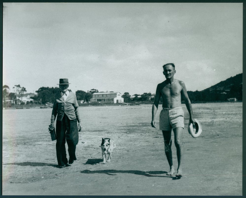 John Henry Herwig (Jack) walking on a dry Narrabeen Lake bed, with his father John Phillip Herwig and dog Lassie.
