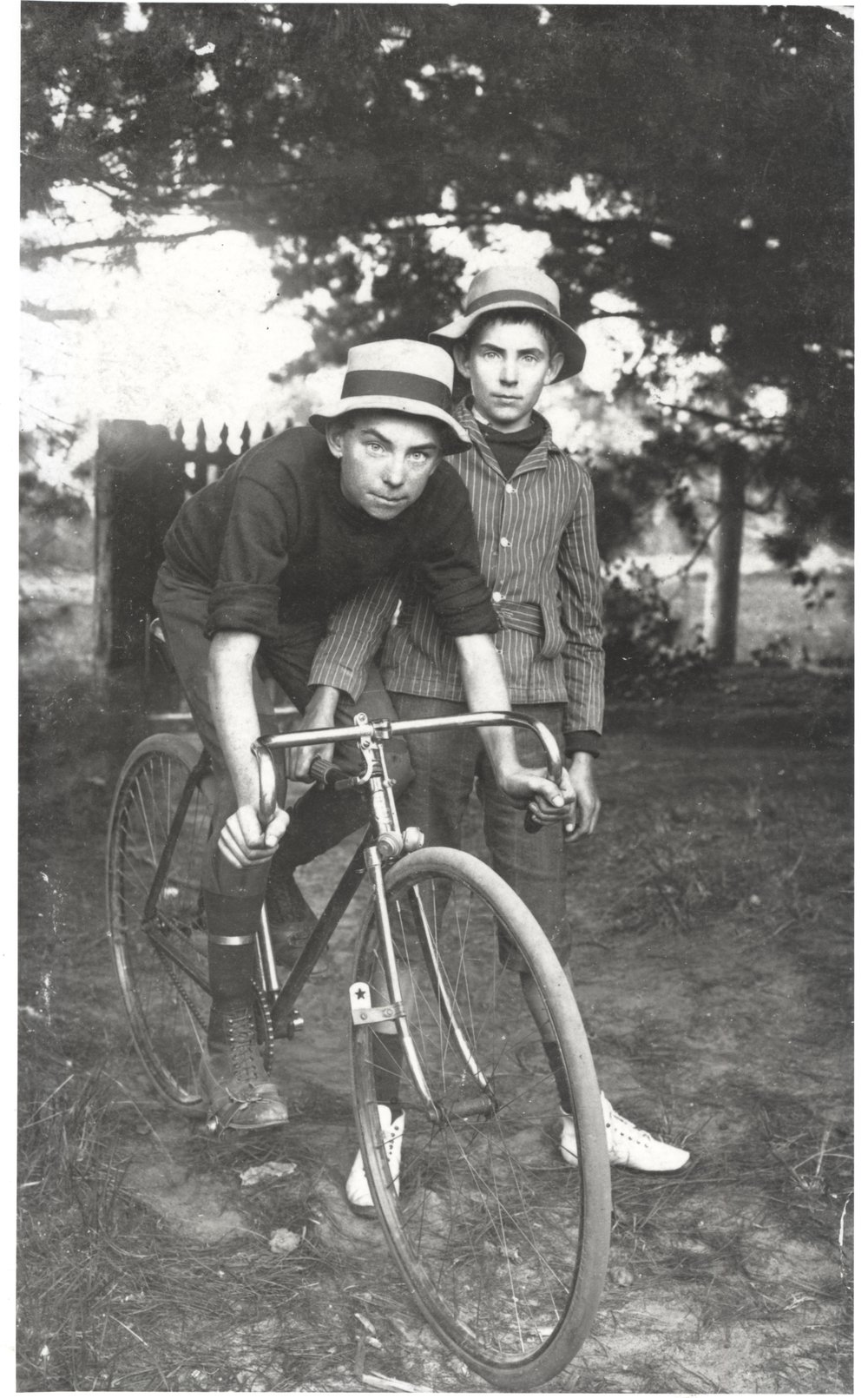 Arthur Larkin and brother Leslie Larkin riding bicycles at Waratah Farm, Ingleside