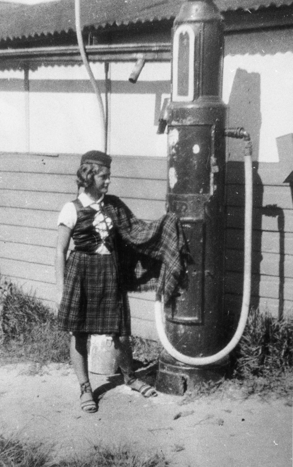 Jean Holburn next to a petrol pump, Dee Why