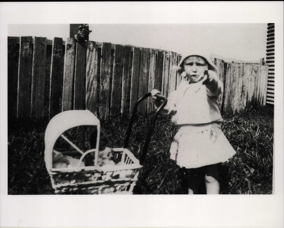 Jean Phillips playing with doll's pram in North Curl Curl