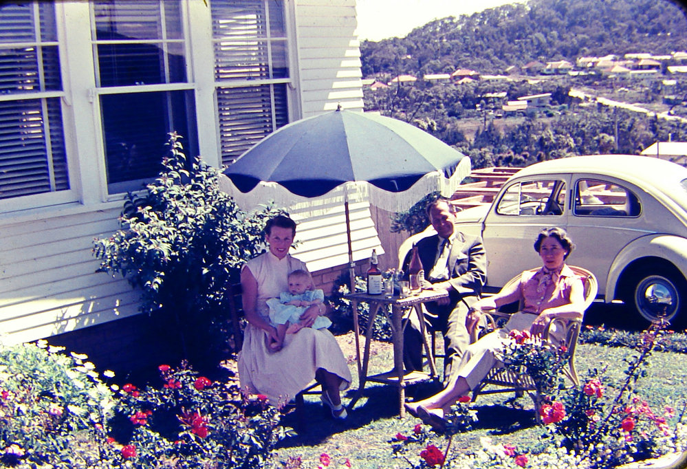 Butler family sitting outside of house at 25 Milga Road, Avalon. 