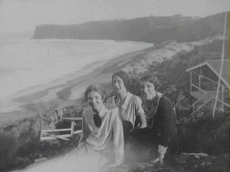 Dot, Betty Pollock and Ede sitting on rock above the Camp House, c1920