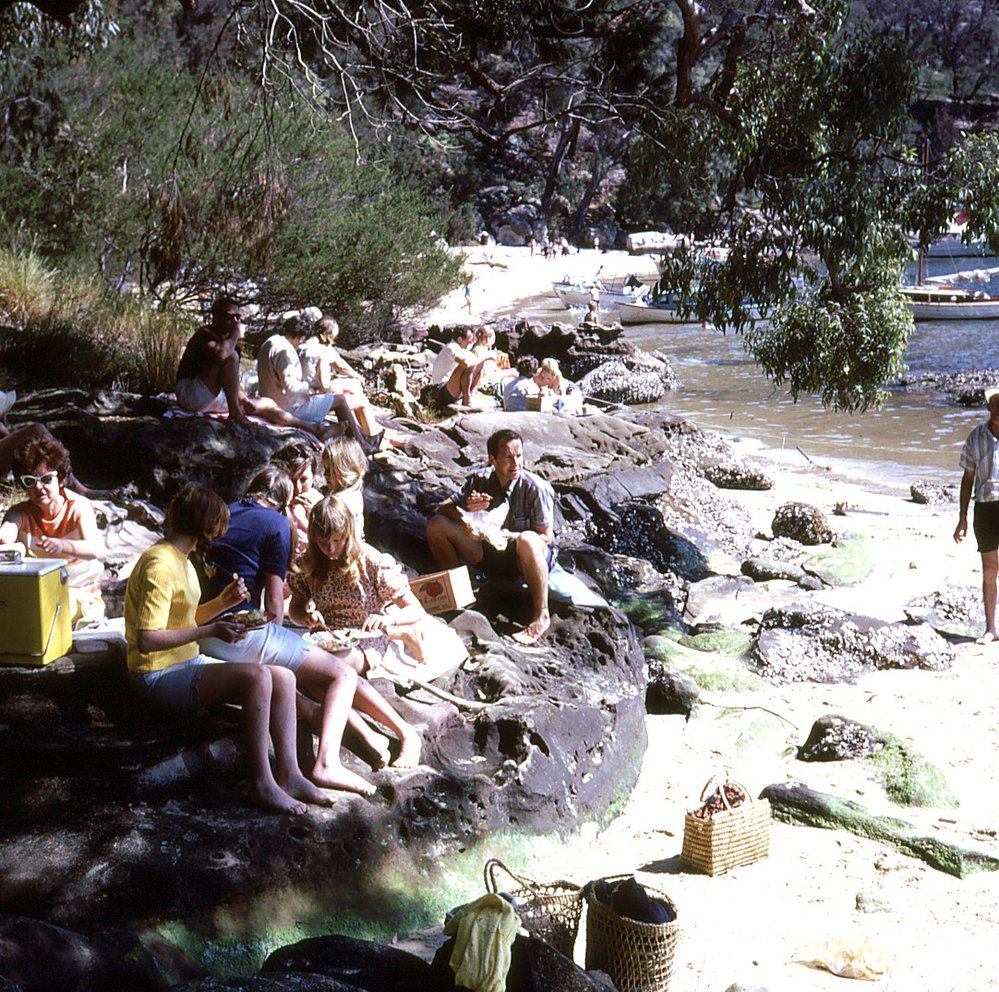 Groups of people picnicking at Hallett's Beach, Ku-ring-gai Chase National Park