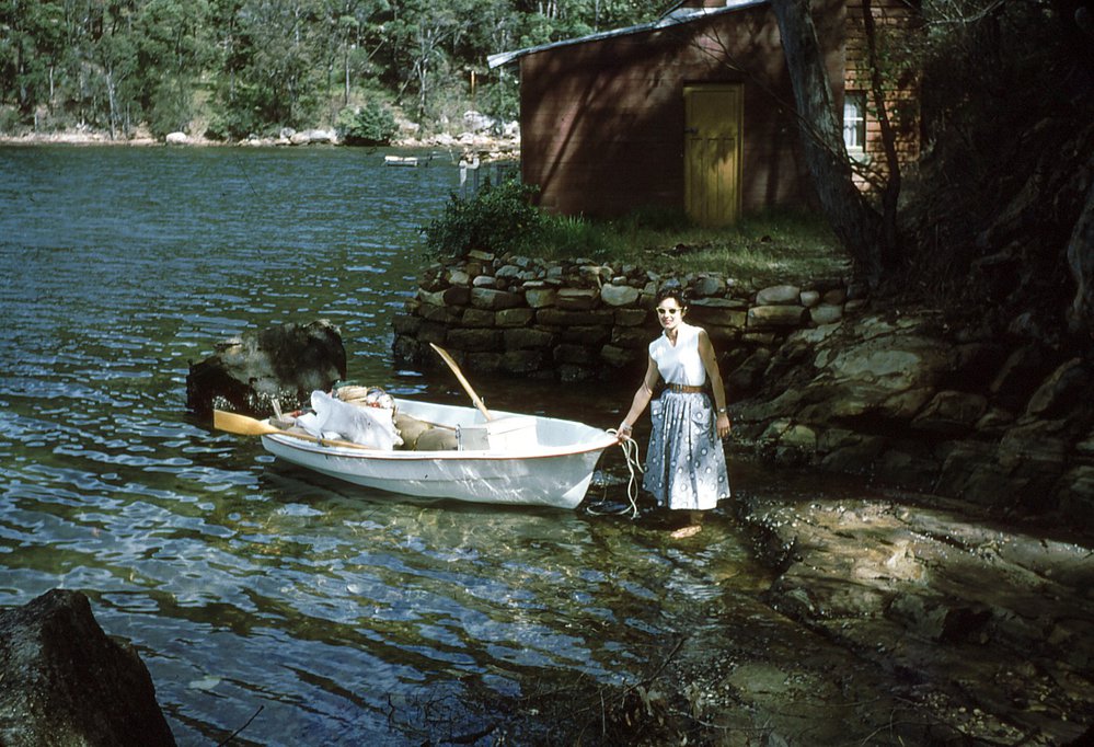 Margaret Pilgrim arriving by row boat to the property at McCarrs Creek West