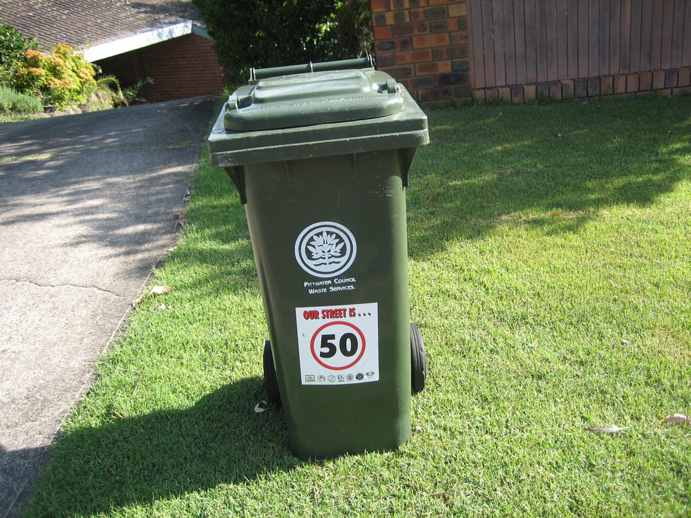 Garbage bin on grass outside a house in Bungoona Avenue, Elanora Heights