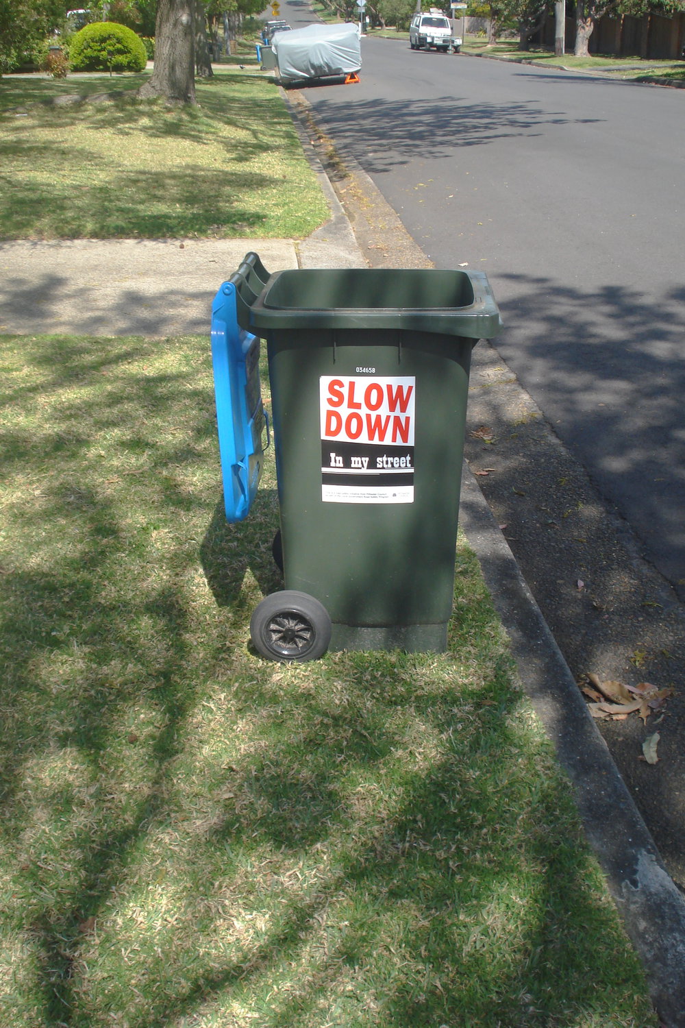 Garbage bin with 'Slow down in my street' written on it in Marilinga Avenue, Elanora Heights. 