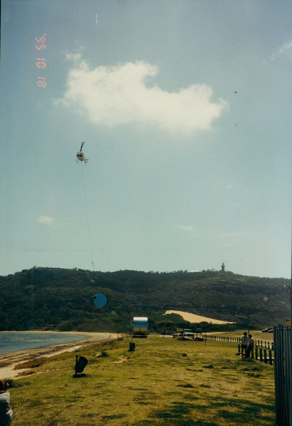 Helicopter delivering a water tank to Palm Beach, 1995