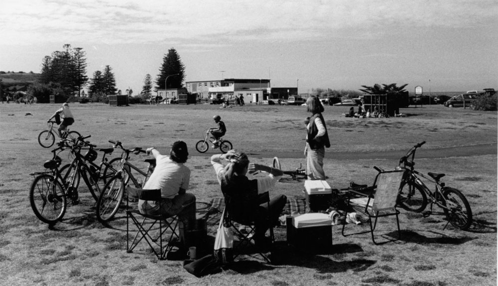 Picnickers' at Apex Park, Mona Vale, watching children riding their bicycles