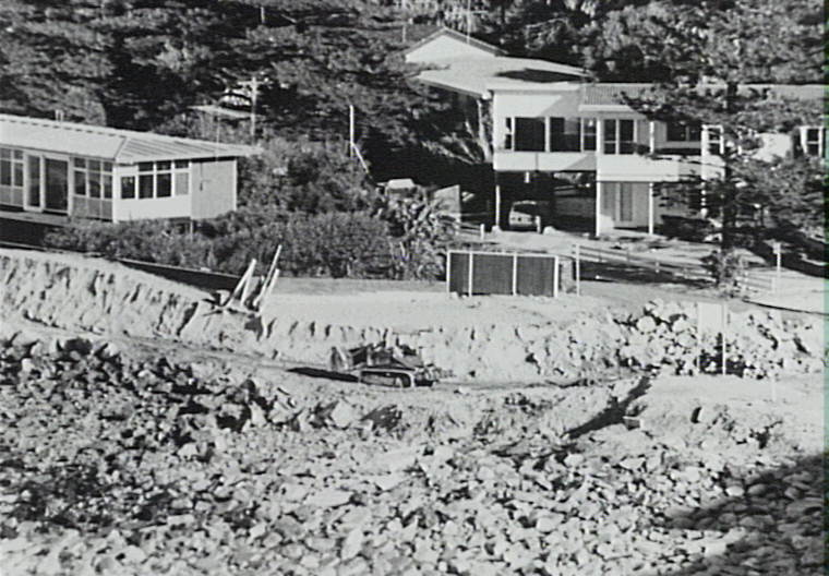 Bulldozer working on beach after storm damage, Newport, 1974