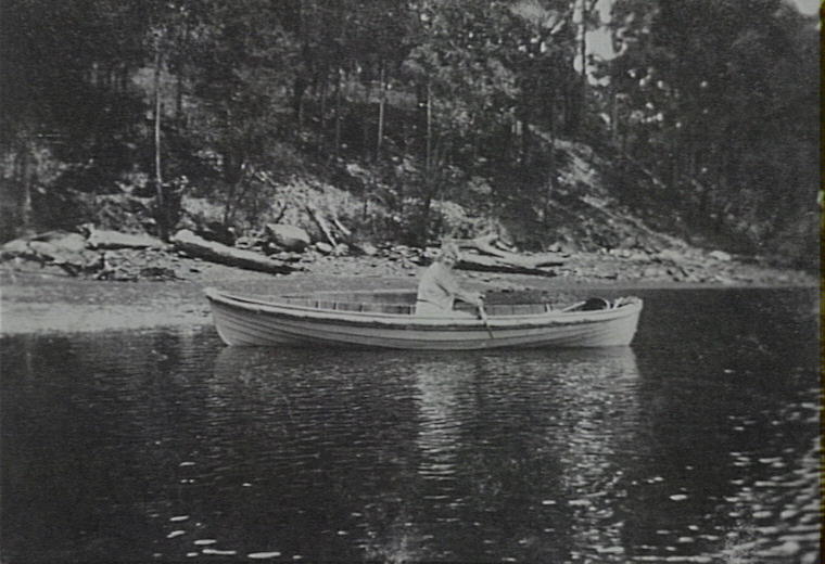 Woman in a timber row boat, Pittwater, 1915