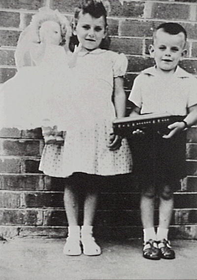 Karen and Stephen Simpson with the bride doll and train they received for Christmas, 1959