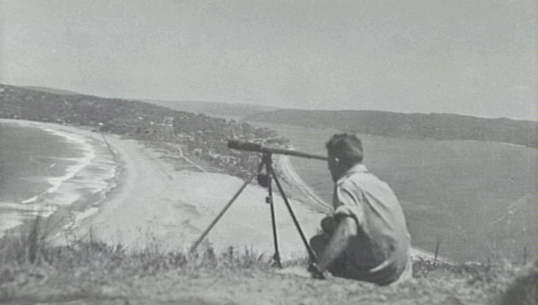 Noel Vern using a telescope  on Barrenjoey Headland to check for enemy aircraft, Palm Beach, 1942