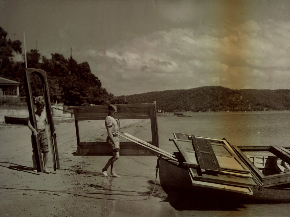 Workers carrying materials up to Barrenjoey Lighthouse from boats on Station beach