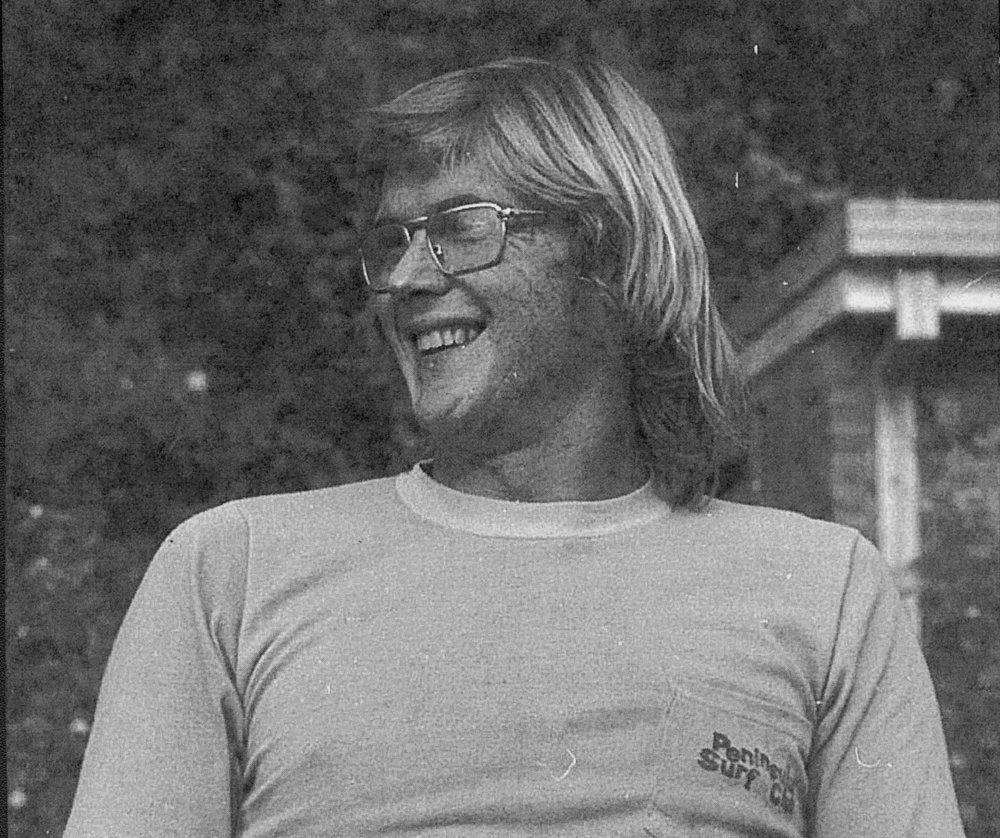 Surfer wearing tee shirt with the Peninsula Surf Club logo, Palm Beach, 1975
