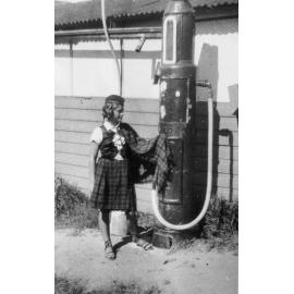 Jean Holburn next to a petrol pump, Dee Why