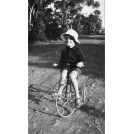 Child on bicycle in Glen Street, Belrose