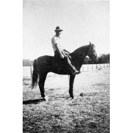 Harry Brodie on a horse in backyard of family home, 1339 Pittwater Road Narrabeen