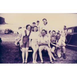 Group of young people sitting on car at Bilgola Beach, 1948
