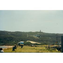 Helicopter delivering a water tank to palm Beach, 1995