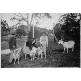 Douglas family with goats in the yard of their home in Mona Vale