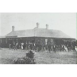 Group of bicycle riders outside the Newport Hotel, 1907
