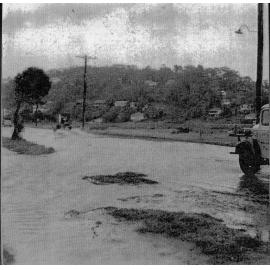 Looking south Pittwater Road opposite Namona Street, North Narrabeen, in flood, 1953