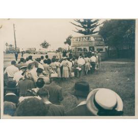 People queuing for bus at Palm Beach, c 1940