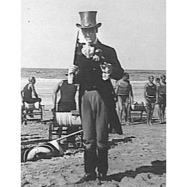 Portrait of unidentified man, wearing a top hat, Manly Beach