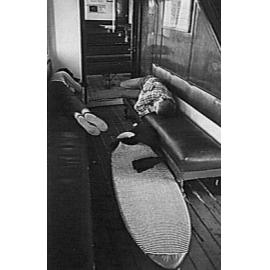 Two surfers asleep on benches aboard a Manly Ferry