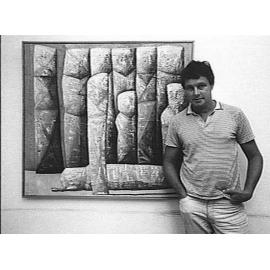 Keith Looby standing in front of one of his works, 1985