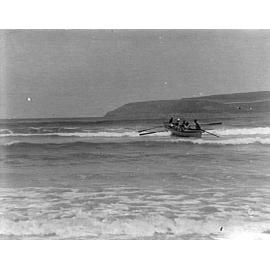 Rowboat going out through waves