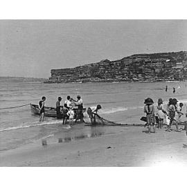 Untangling a fishing net at Freshwater Beach