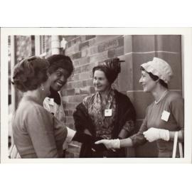 Winifred Atwell being greeted by three women, 1961