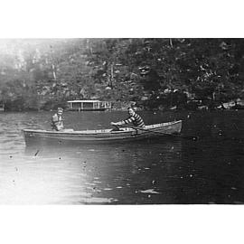 Two members of Manly Surf Club in a small boat on Cowan Creek