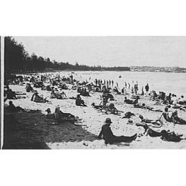 View of Manly Beach showing people and an early-style life-line