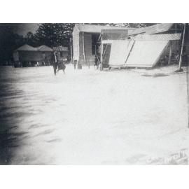 Manly Beach during high seas, showing the dressing sheds