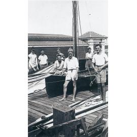 Members of Manly 16ft Skiff Club with skiff