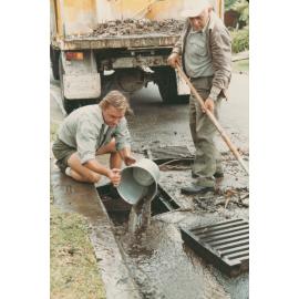 Warringah Council road workers clearing a blocked drain