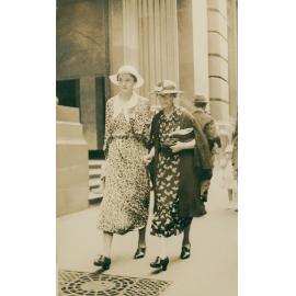 N P King and Principal Miss I Strachan of Manly Grammar School walking down a Sydney Street, c1920s