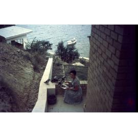 Margaret Pilgrim feeding kookaburras at 'Kanangra', McCarrs Creek West