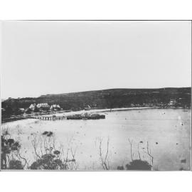 View facing east over Manly Cove showing Manly Wharf with a paddle steamer and nearby buildings, c1875 to c1879