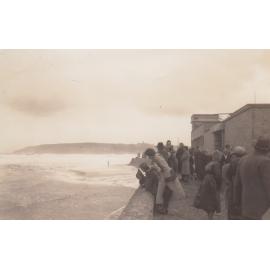 People watching rough seas at Queenscliff Beach, Queenscliff, 1950