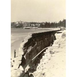 Collapsed sea wall, North Steyne, with St Patrick's Collge and Borambil flats in the distance, Manly, 27th June 1950