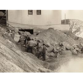 Men working on clearing sand after a strom, North Steyne Surf Life Saving Club, Manly, 1955