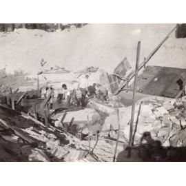 Construction continues on sea wall, showing workmen and debris in channel, North Steyne, Manly, 1955