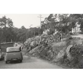 Peronne Avenue, rocky slope and vehicles, Clontarf, 1956