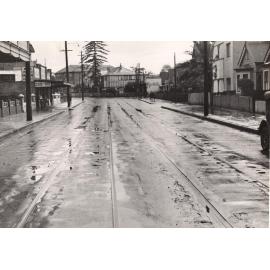 Pittwater Road near a bend and car hire shop, Manly, 29th April 1940
