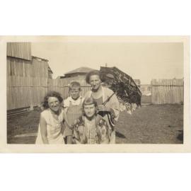 May Fowler and relatives in backyard of her dress maker shop on Pittwater Road Collaroy