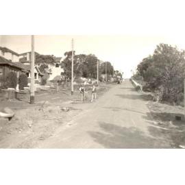 Woodland Street with houses and  people on unfinished nature strip, Balgowlah Heights, c1940s