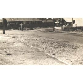 Unidentified street intersection and road drainage, c1940s